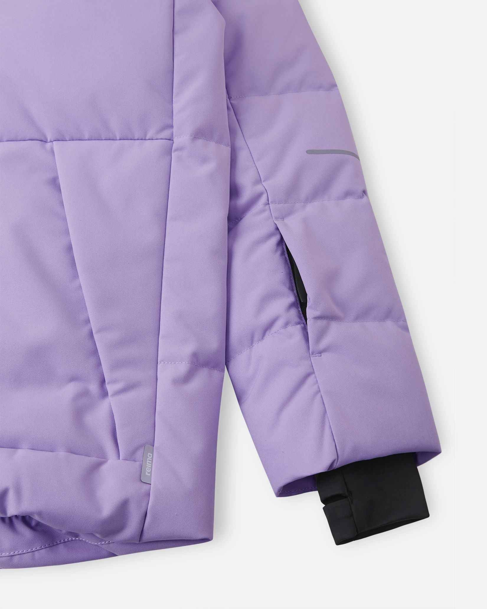Close-up of the left sleeve on the Reima Ranua kids' down ski jacket in blooming lilac, showing the hidden zippered ski pass pocket, reflective safety detailing, and a comfortable inner lycra thumbhole sleeve designed to seal out winter weather.