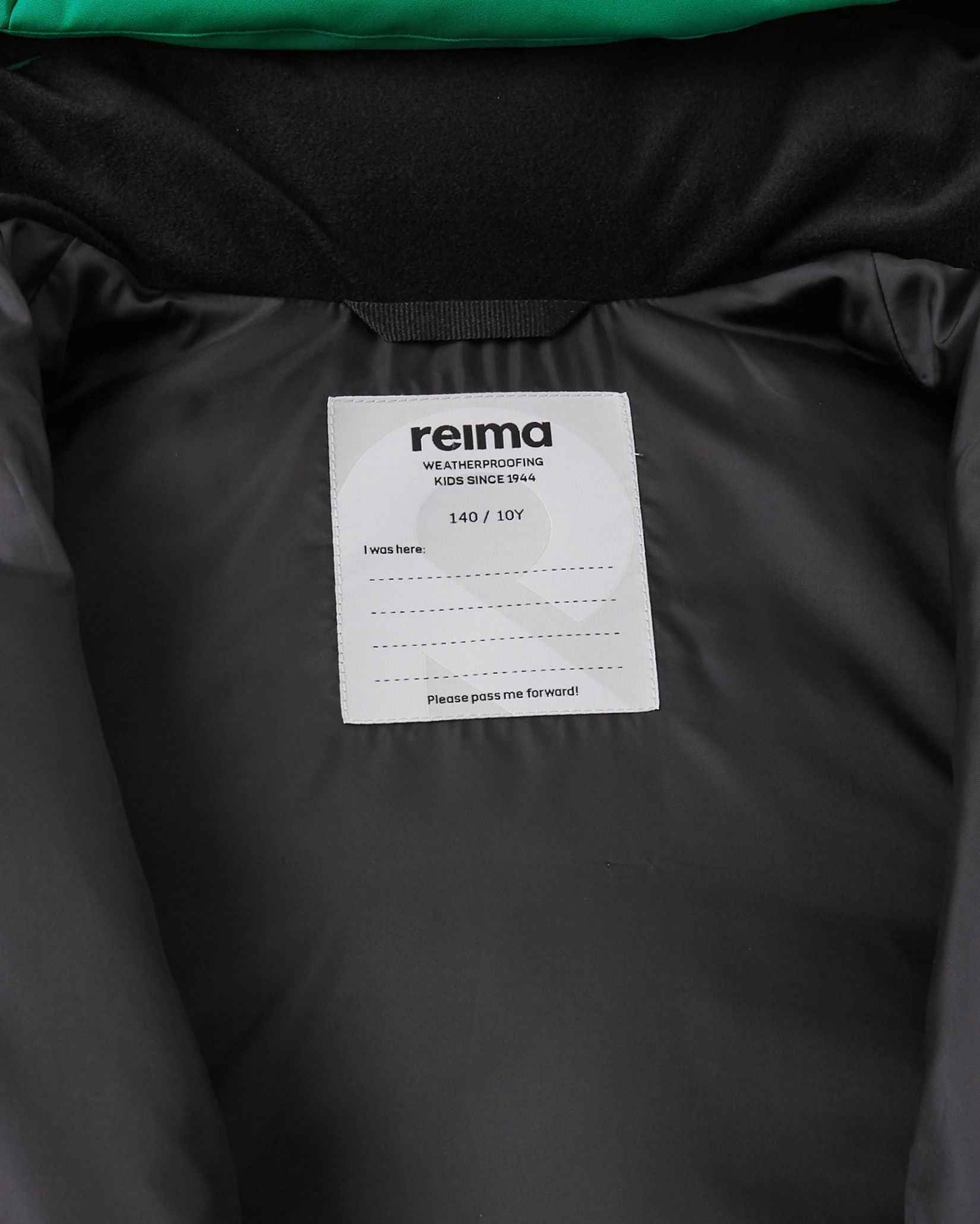 Interior view of the Reima Ranua kids' down ski jacket, highlighting the smooth black inner lining and a white Reima brand name tag with space for a child's details, emphasizing its durable design made to be passed forward.