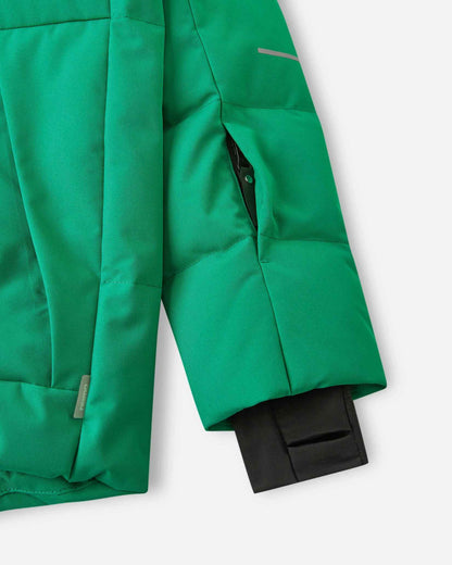 Close-up of the left sleeve on the Reima Ranua kids' down ski jacket in green, showing the hidden zippered ski pass pocket, an adjustable velcro cuff, and the comfortable inner lycra thumbhole sleeve designed to seal out snow.