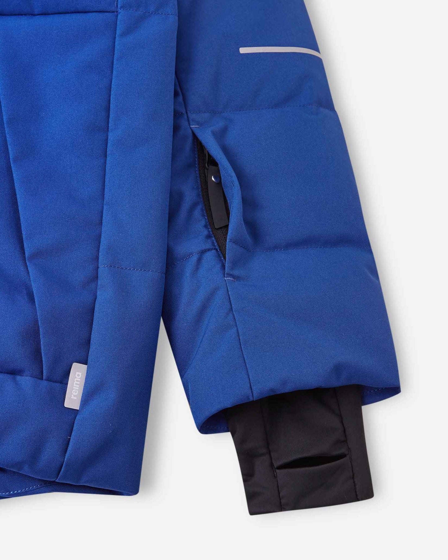 Close-up of the left sleeve on the Reima Ranua kids' down ski jacket in twilight blue, showing the hidden zippered ski pass pocket, reflective safety detailing, and the comfortable inner lycra thumbhole sleeve designed to seal out cold and snow.