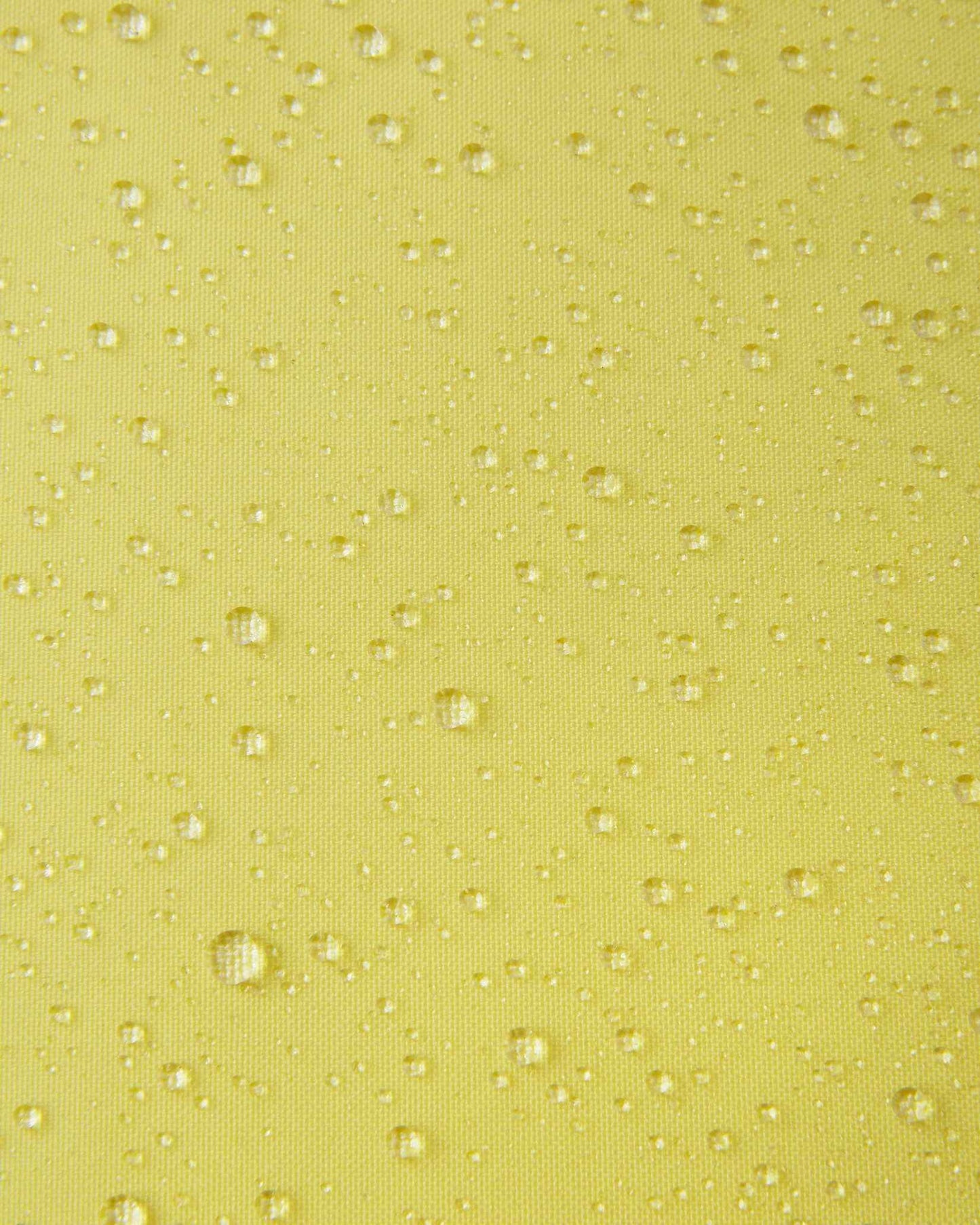 A detailed close-up texture shot of water droplets beading up cleanly on the bright yellow water-repellent fabric of a Reima Ranua kids' down ski jacket, demonstrating its durable weather-resistant performance for outdoor winter play.