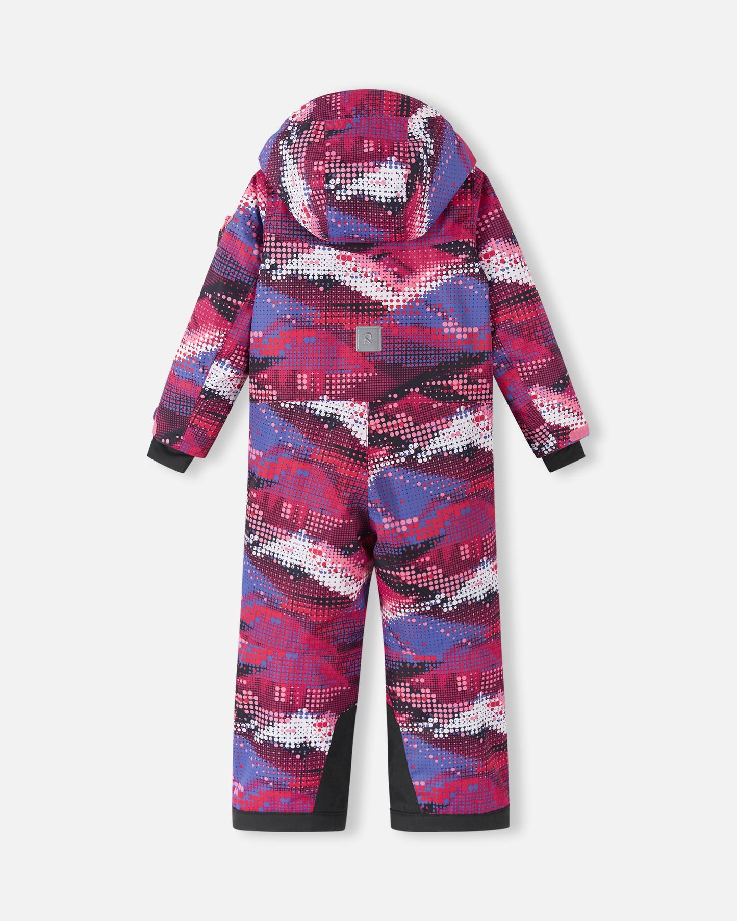 Full back view of the Reima Reach girls' ski suit in a vibrant rosy berry geometric pattern, highlighting the attached winter hood, a high-visibility reflective safety patch centered on the back, and heavy-duty black reinforced seat and ankle panels.