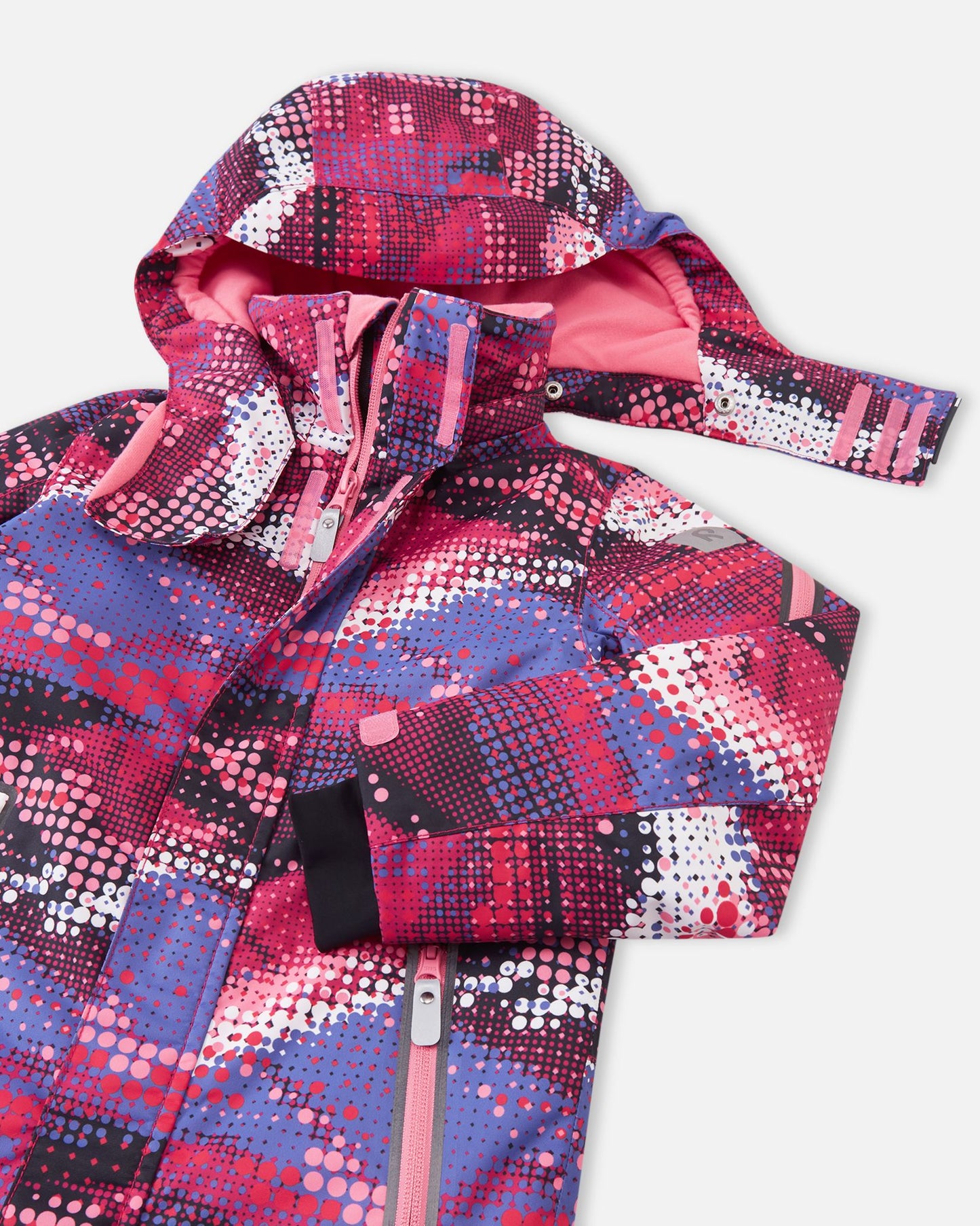 Detailed upper front view of the rosy berry Reima Reach girls' waterproof ski suit, highlighting the protective winter hood, cozy pink fleece-lined high collar, and durable zippers designed to keep out harsh winter winds.