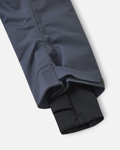 Close-up of the sleeve cuffs on the Reima Reach soft black kids' snowsuit, displaying adjustable outer velcro straps and snug inner lycra cuffs with thumb holes to completely lock out snow and cold drafts.