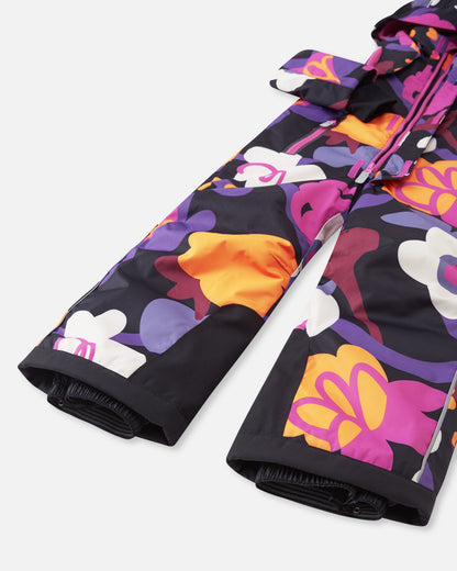 Detail shot of the lower legs on the Reima Reach kids' ski suit, highlighting the heavy-duty black reinforced inner kick patches for ski edge protection and stretchy inner snow gaiters designed to seal tightly around ski boots to keep powder out.