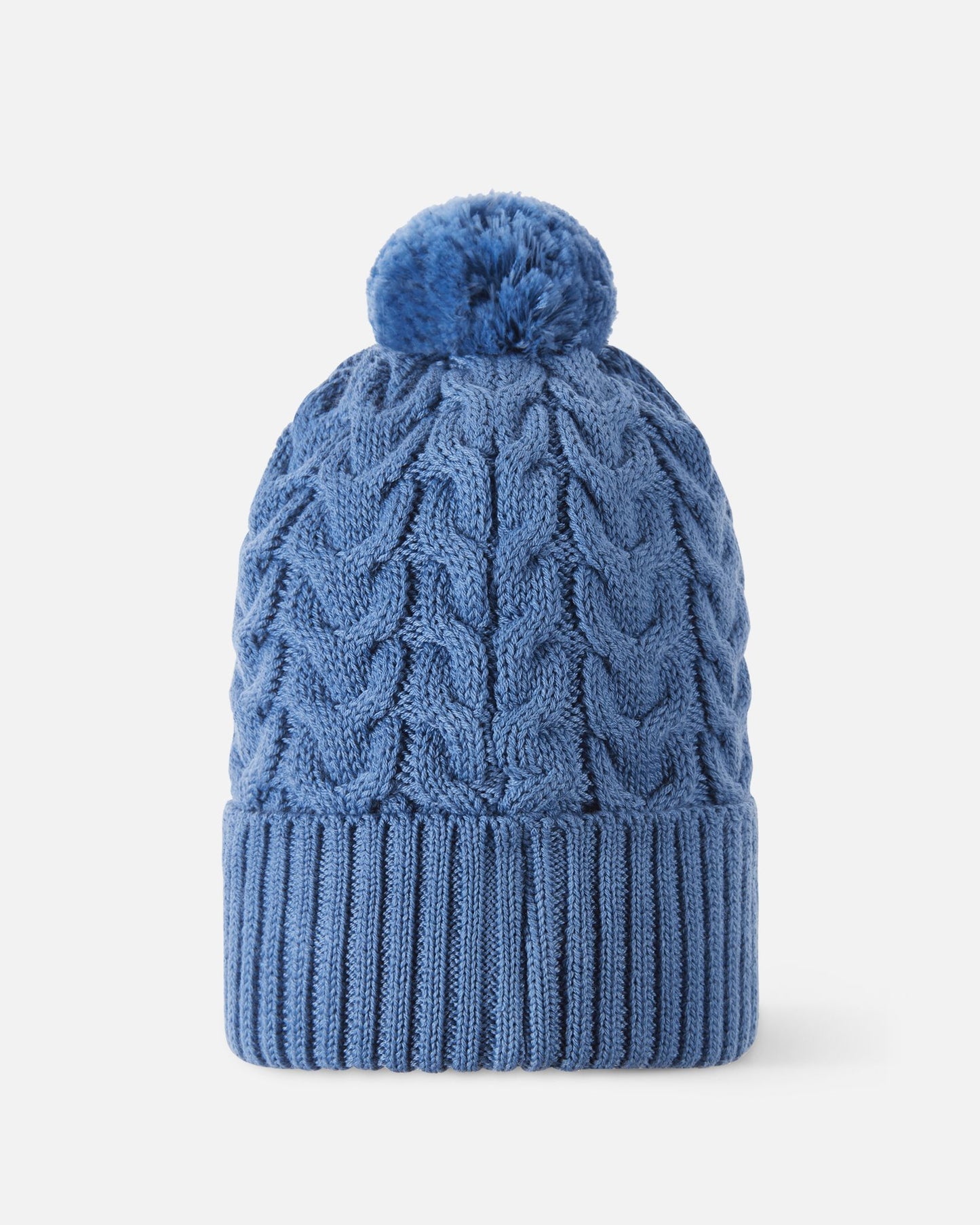 Back flat lay view of the blue ocean Reima Routii kids' knitted beanie, showcasing the seamless continuation of the traditional cable knit pattern and the soft yarn pom-pom engineered for cold weather warmth.