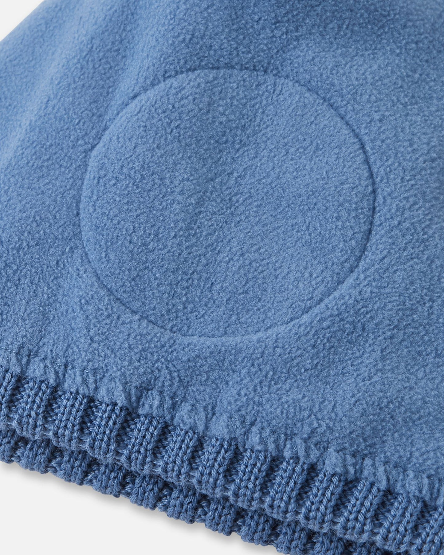 Detailed interior view of the blue ocean Reima Routii kids' beanie. The image reveals the fully lined, soft thermal fleece interior and the specialized circular windproof earpiece inserts designed to protect children's ears from cold winter winds.