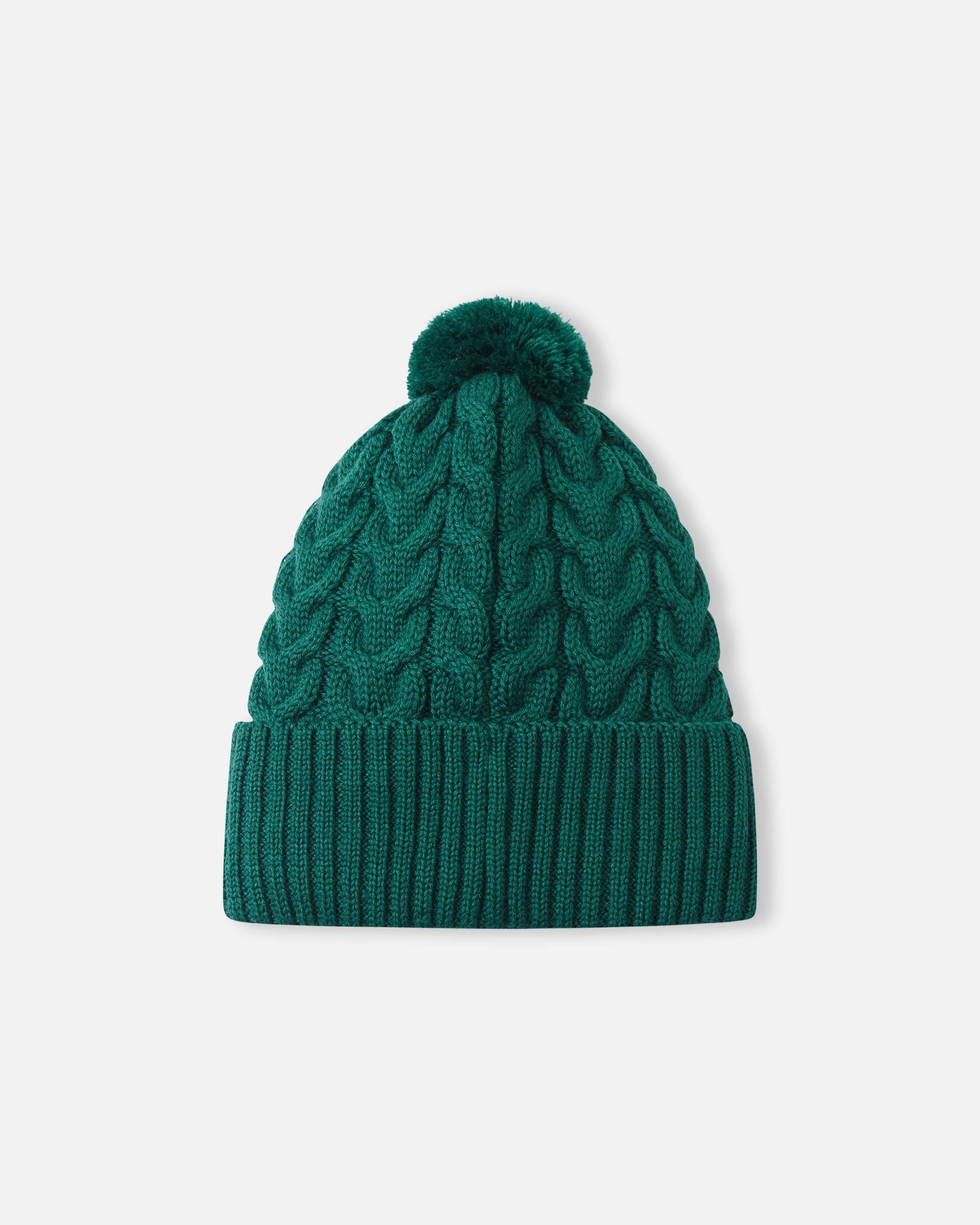 Back flat lay view of the deeper green Reima Routii kids' knitted beanie, displaying the continuous warm cable knit pattern and cozy yarn pom-pom designed to retain body heat during winter sports.