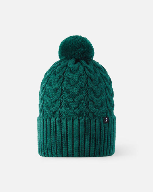 Front flat lay view of the deeper green Reima Routii kids' knitted winter hat. The image showcases the premium merino wool-blend yarn, a stylish cable knit texture, and a matching soft yarn pom-pom on top.
