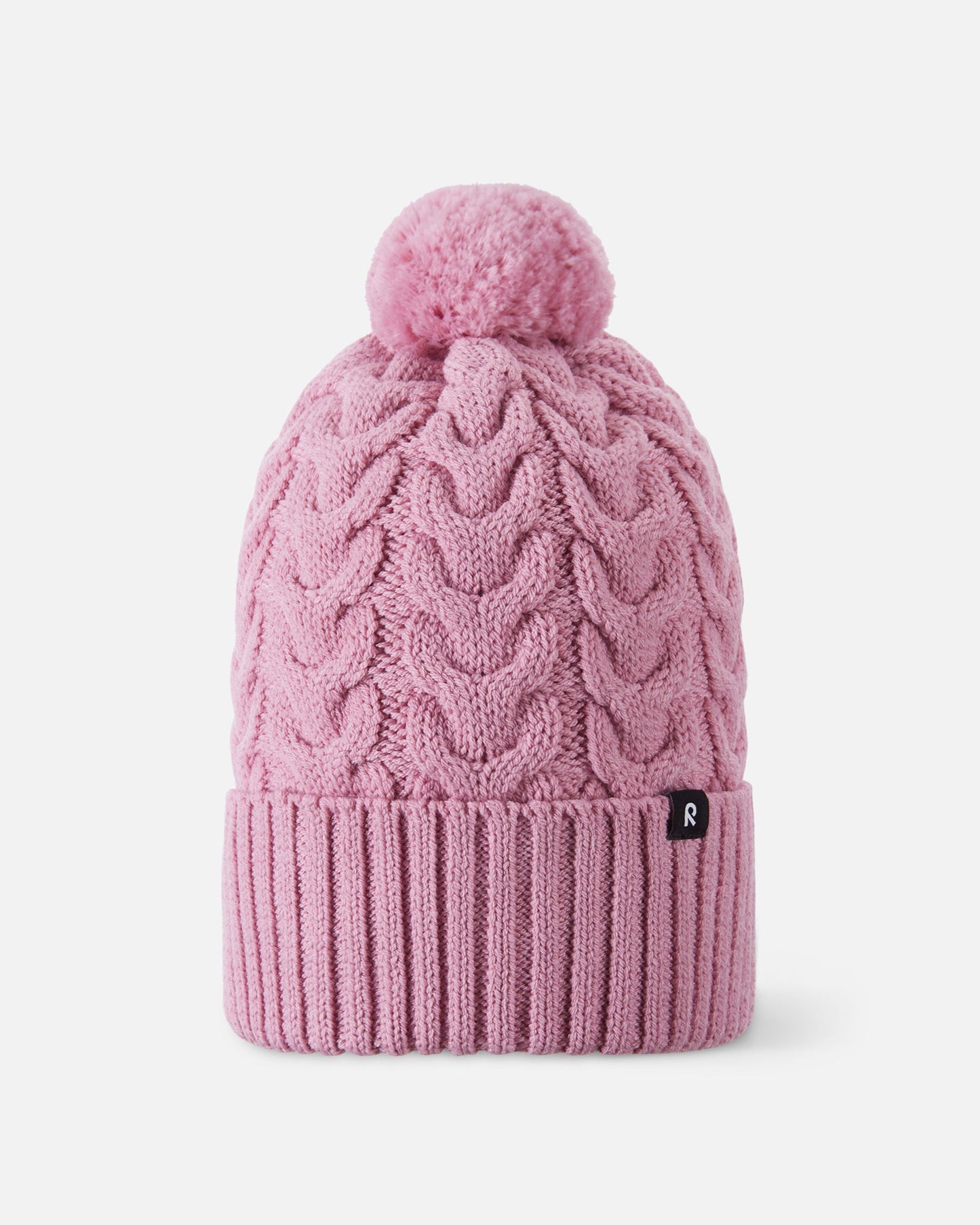 Front flat lay view of the grey pink Reima Routii kids' knitted winter beanie. The image highlights the classic cable knit design, a wide ribbed fold-up hem for a secure fit, a matching yarn pom-pom, and the small black Reima logo tag.