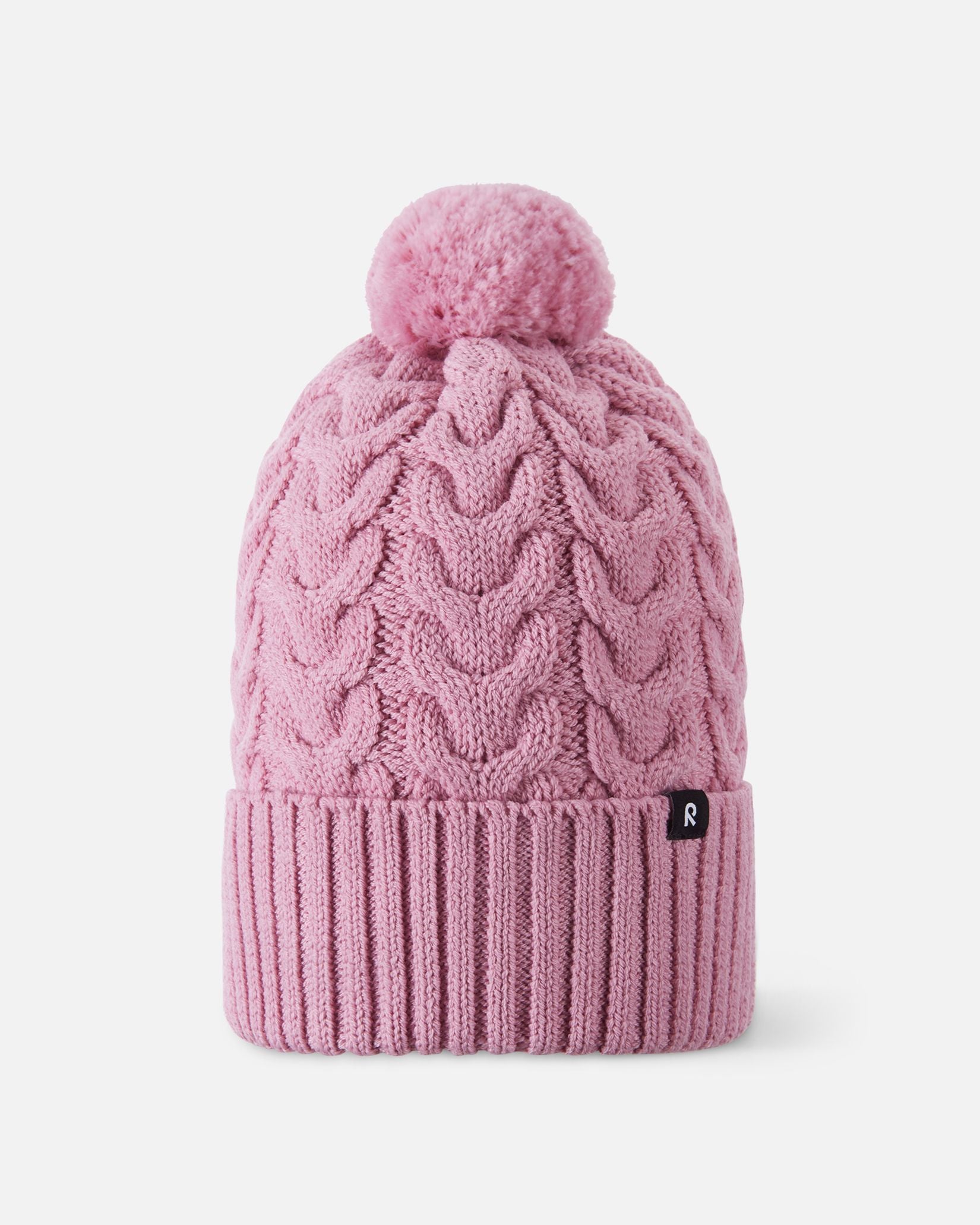 Front flat lay view of the grey pink Reima Routii kids' knitted winter beanie. The image highlights the classic cable knit design, a wide ribbed fold-up hem for a secure fit, a matching yarn pom-pom, and the small black Reima logo tag.