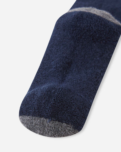 Detailed close-up of the footbed and toe area on the navy blue Reima Saapas kids' wool socks, highlighting the plush knit texture and the durable dark grey reinforced toe.
