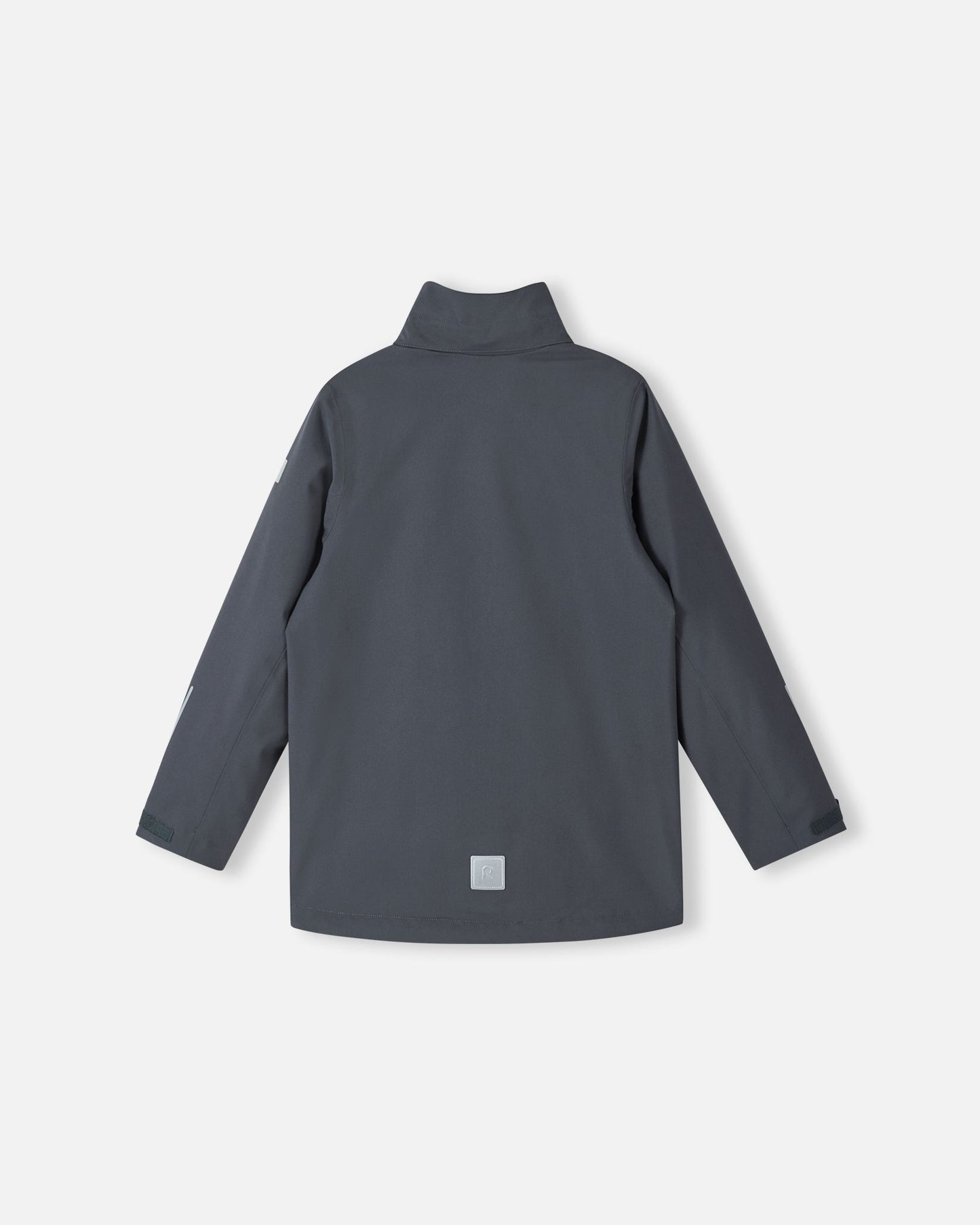 Back view of the Reima Saarela kids waterproof fall jacket in soft black, shown without the detachable hood to display the high protective collar. Features include a visible lower-back reflective patch and adjustable sleeve cuffs.