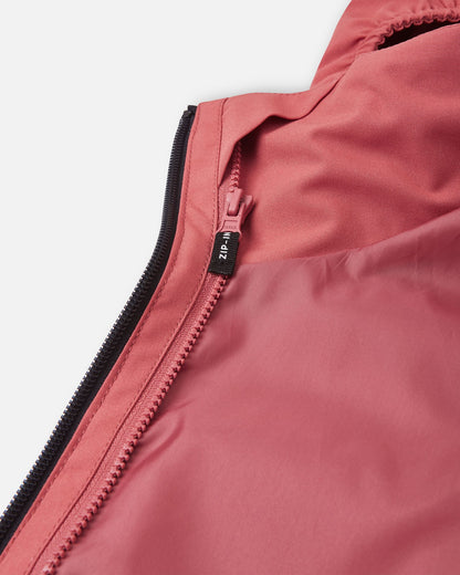 Close-up of the inside zipper on the Reima Saarela kids' red clay shell jacket, showing the functional "Zip-In" system that allows compatible Reima mid-layers to be attached for extra winter warmth.