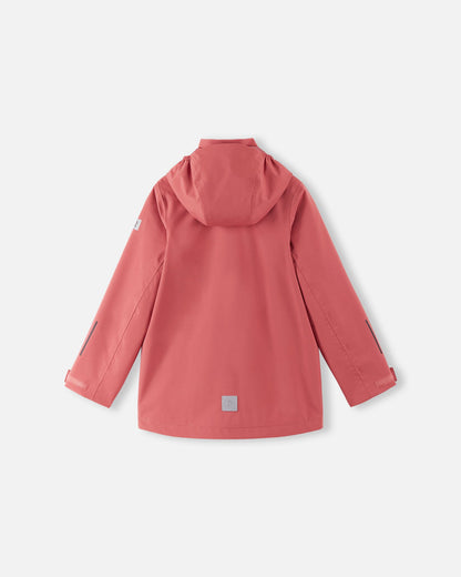 Back view of the red clay Reima Saarela kids' waterproof shell jacket, showing the attached hood, dropped back hem for extra coverage, and a highly visible reflective safety patch near the hemline.
