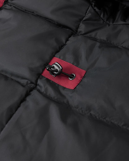 A close-up image of the interior of the maroon Reima Serkkula kids' parka, showing the black quilted inner lining with a maroon panel and a drawstring toggle for waist adjustment.