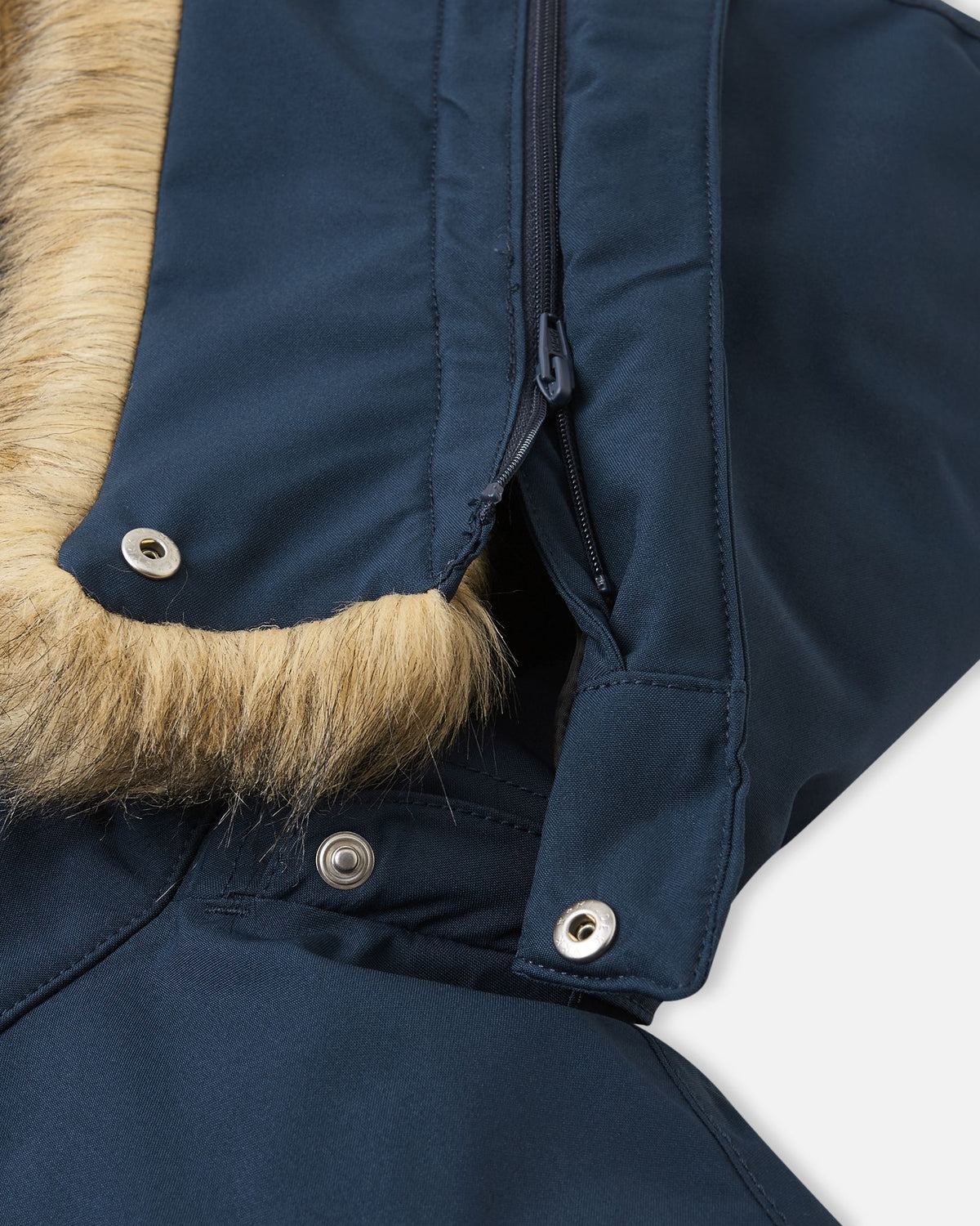 Detailed view of the detachable hood attachment system on the navy Reima Serkkula parka, showing snap fasteners and zipper construction.