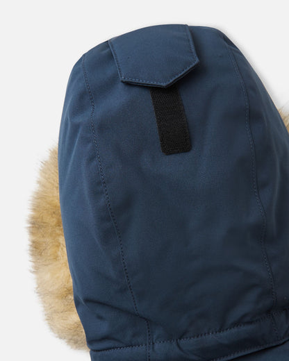Macro shot of the navy Reima Serkkula parka hood crown, highlighting the Velcro tab used for depth and fit adjustment.