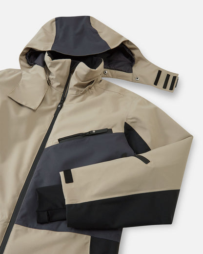 Close-up of the upper half of the Reima Skaulo earthy beige kids ski suit, highlighting the continuous front zip, adjustable detachable hood, and secure zippered chest pocket.