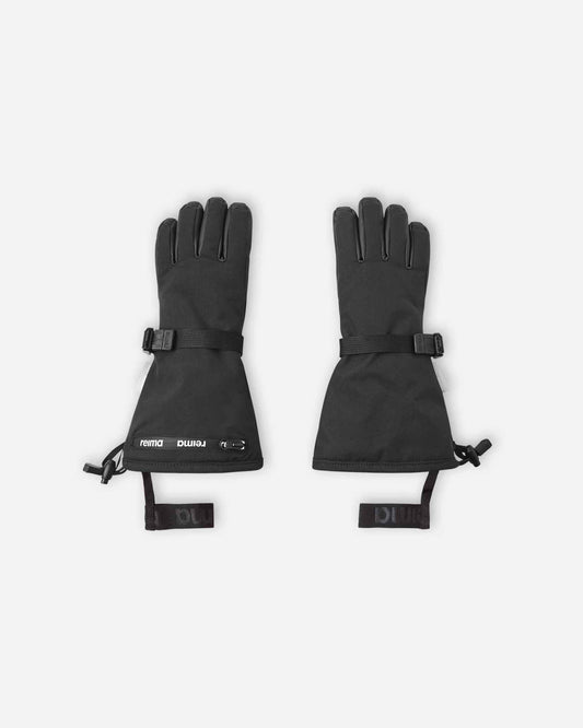 Flat lay view of the backs of the classic black Reima Skimba kids' ski gloves, featuring an extra-long snow-blocking gauntlet cuff, an adjustable wrist strap, and elastic safety wrist leashes.