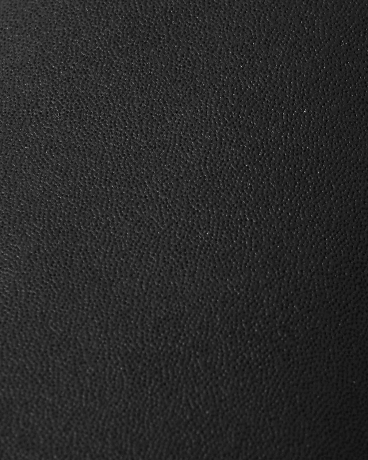 Macro close-up of the durable, textured black reinforced material used on the palms of the Reima Skimba kids' ski gloves, engineered for superior grip and tear resistance during winter sports.