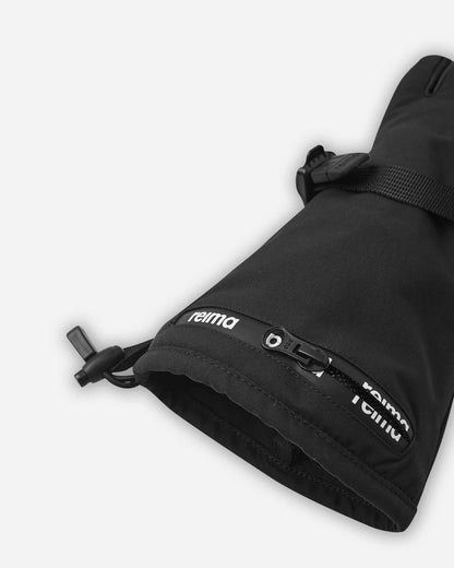 Close-up detail of the extra-long cuff on the black Reima Skimba kids' ski gloves, highlighting the convenient water-resistant zippered ski pass pocket featuring the Reima logo.