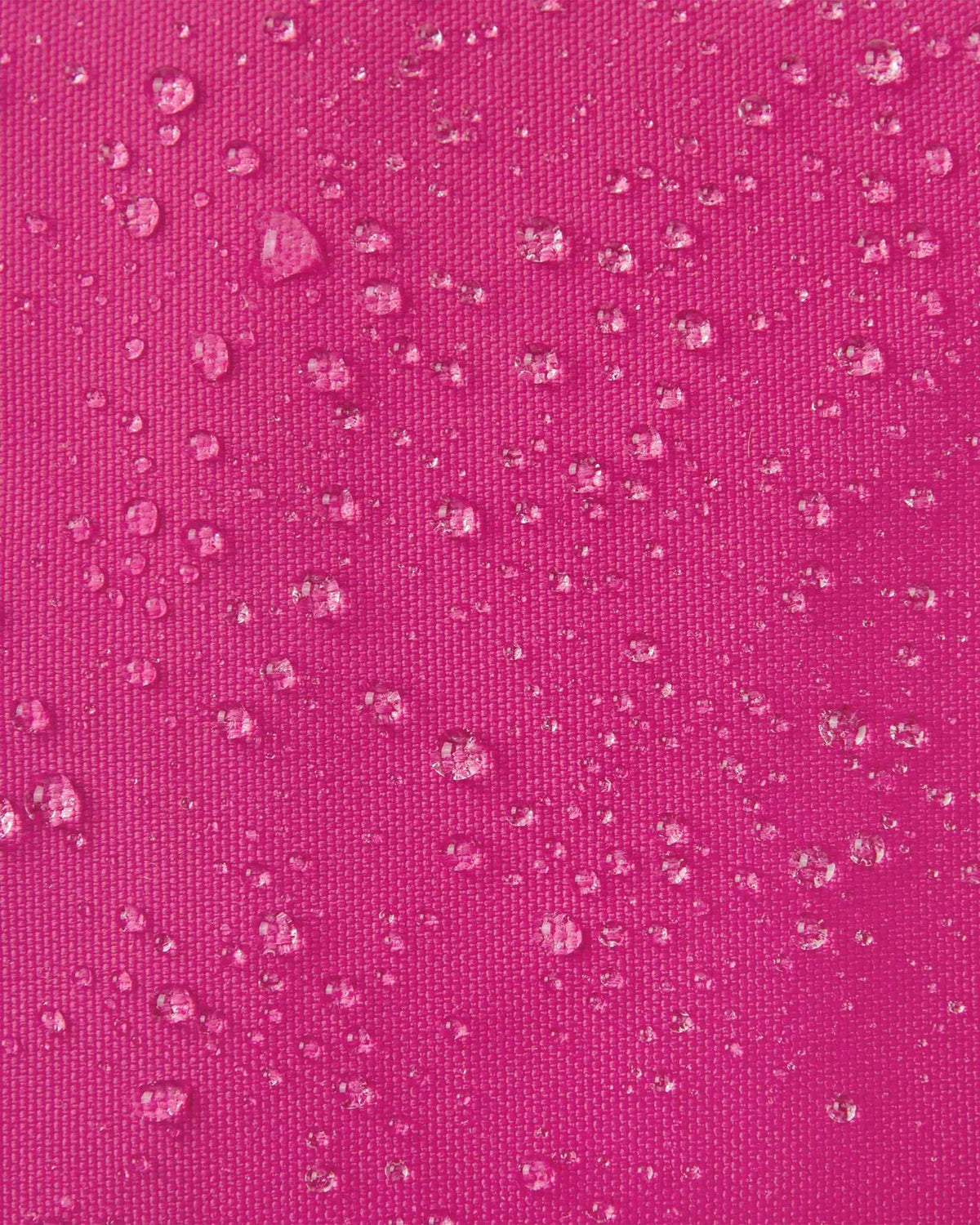 Macro close-up of water droplets actively beading off the rosy berry pink outer shell of the Reima Skimba kids' ski gloves, highlighting the highly effective waterproof and snow-repellent technical fabric.