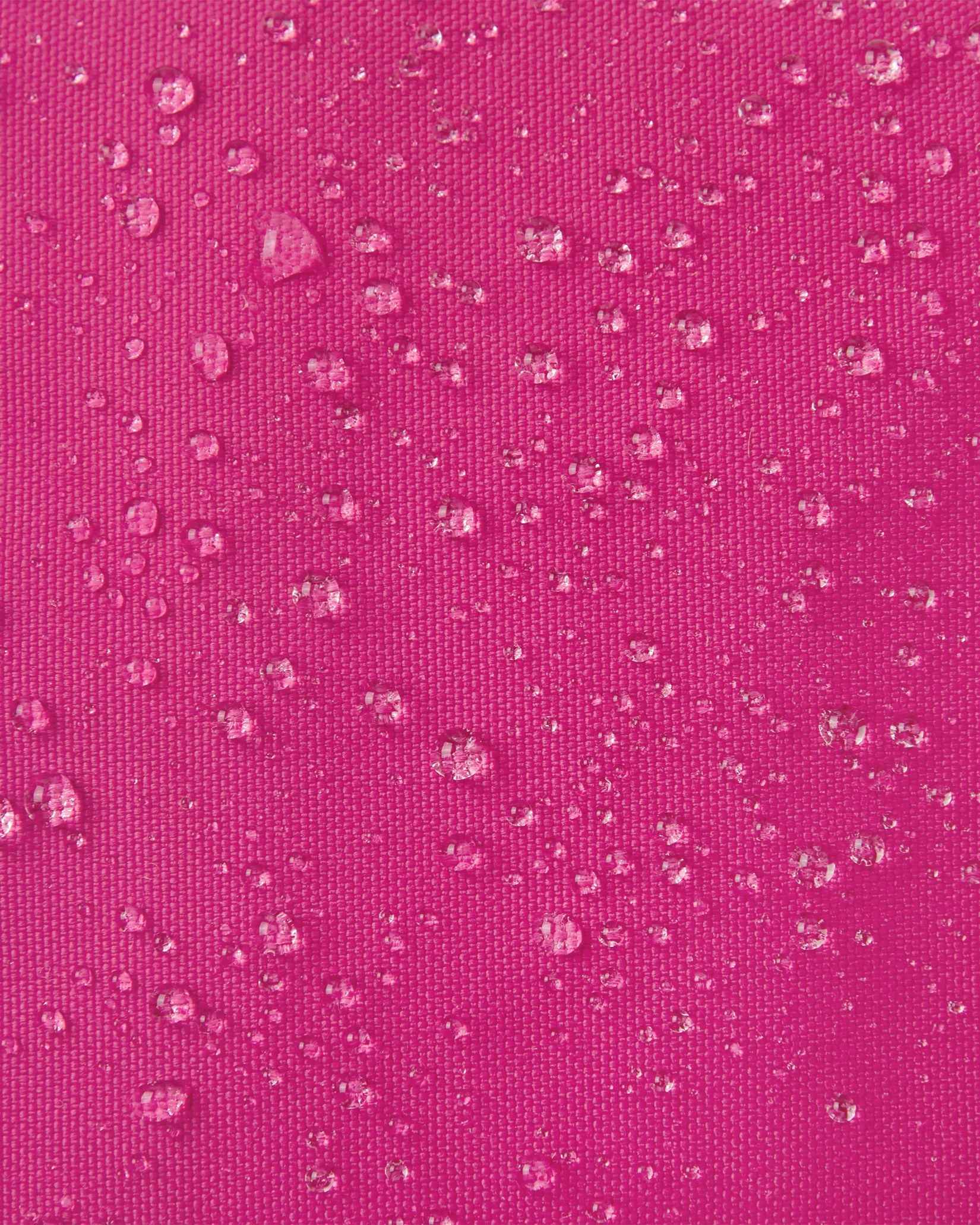 Macro close-up of water droplets actively beading off the rosy berry pink outer shell of the Reima Skimba kids' ski gloves, highlighting the highly effective waterproof and snow-repellent technical fabric.