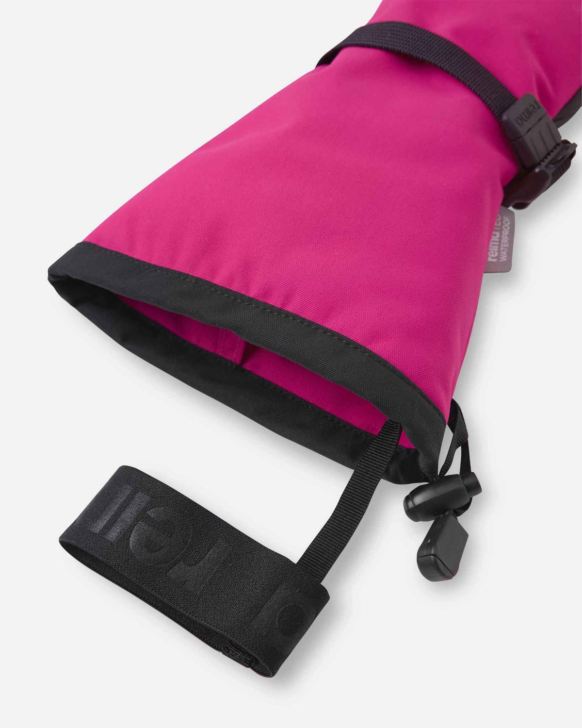 Close-up detail of the extra-long cuff opening on the rosy berry pink Reima Snoukka kids' ski mittens, highlighting the attached elastic safety wrist leash designed to prevent dropped gear on the mountain.