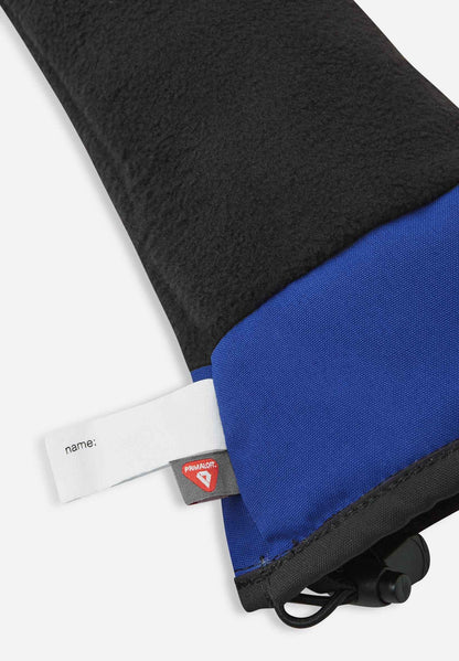 Detail of the inner cuff of the twilight blue Reima Snoukka kids' ski mittens, showing the soft thermal fleece lining, a built-in name tag, and the premium PrimaLoft insulation label indicating high-performance thermal regulation.