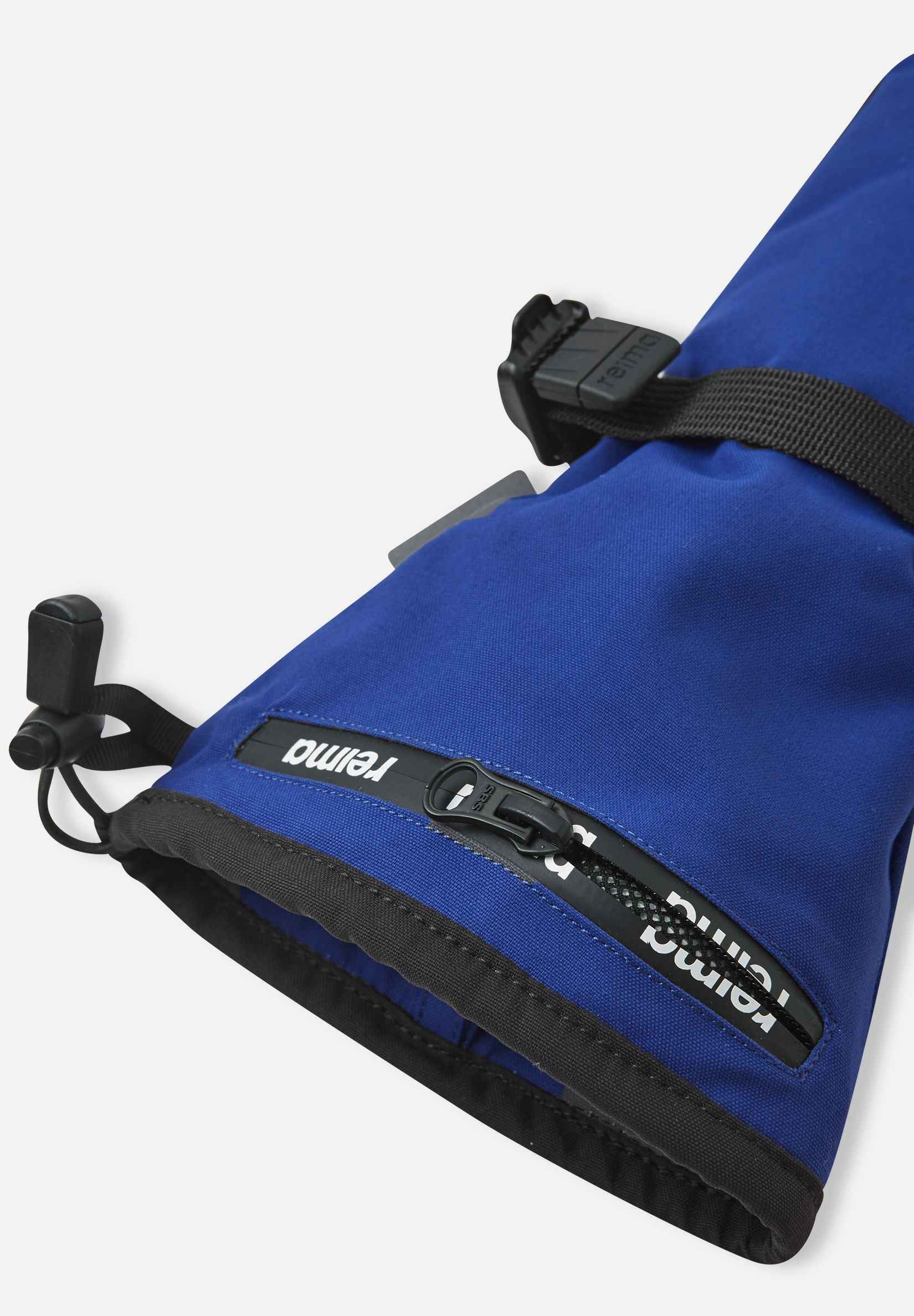 Close-up detail of the extra-long cuff on the twilight blue Reima Snoukka kids' ski mittens, highlighting the convenient water-resistant zippered ski pass pocket and adjustable wrist strap.