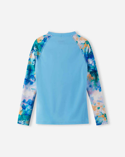 Back view of the fresh blue Reima Sukeltaja kids' long sleeve swim shirt, showcasing the seamless athletic shoulder construction and quick-drying UPF 50+ sunproof fabric designed for active water play.