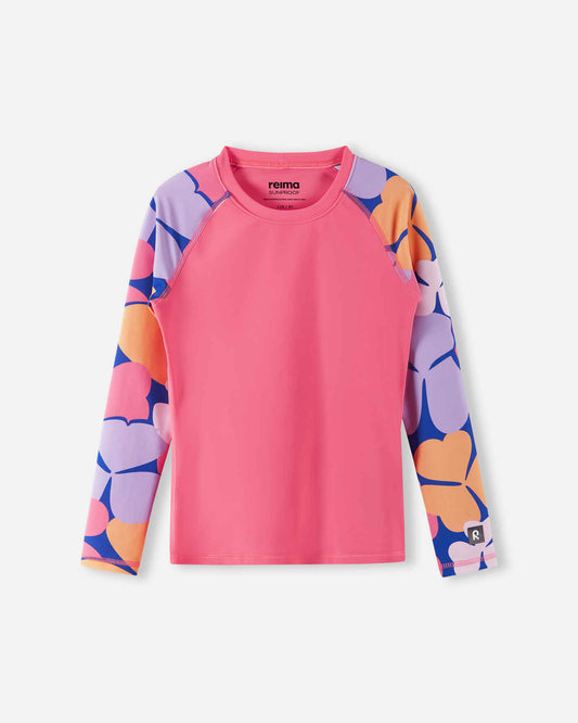 Front view of the Reima Sukeltaja kids' UPF 50+ sunproof rash guard, showcasing a solid soft coral body paired with bold, oversized floral print long sleeves for premium summer sun protection.