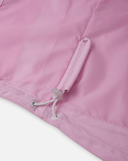 Inside view of the Reima Sulkava girls' jacket lower hem, highlighting the concealed, adjustable bungee cord and toggle system designed to cinch the waist tightly and block out cold autumn drafts.