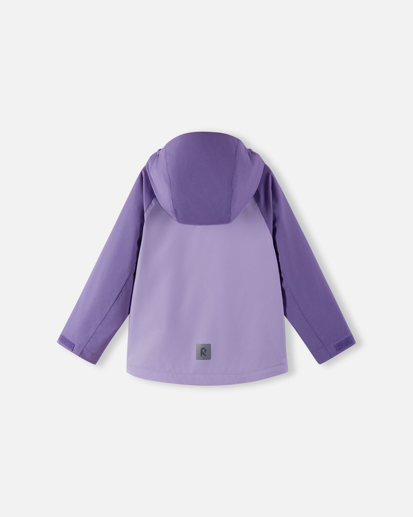 Full back view of the Reima Sulkava girls' fall jacket in blooming lilac, showing the attached protective hood and a square reflective safety patch positioned near the hem for excellent low-light visibility.