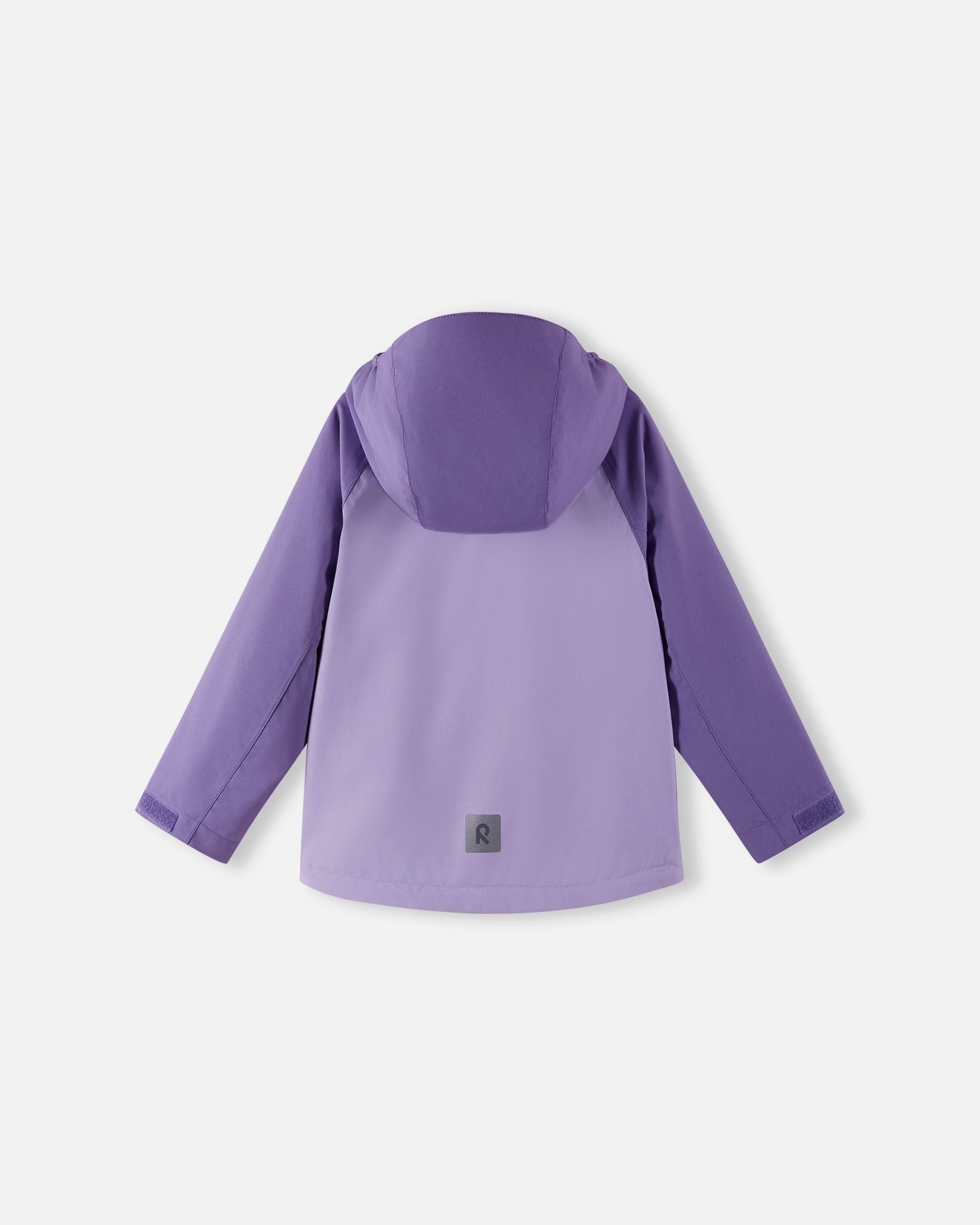 Full back view of the Reima Sulkava girls' fall jacket in blooming lilac, showing the attached protective hood and a square reflective safety patch positioned near the hem for excellent low-light visibility.