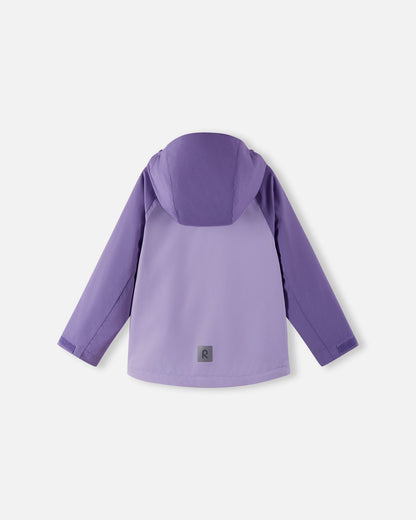 Full back view of the Reima Sulkava girls' fall jacket in blooming lilac, showing the attached protective hood and a square reflective safety patch positioned near the hem for excellent low-light visibility.