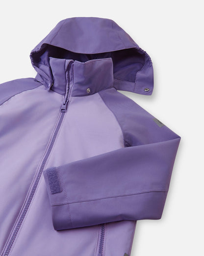 Close-up of the child-safe detachable hood on the blooming lilac Reima Sulkava fall jacket, illustrating the durable snap buttons designed to release easily if the hood gets caught during outdoor play.