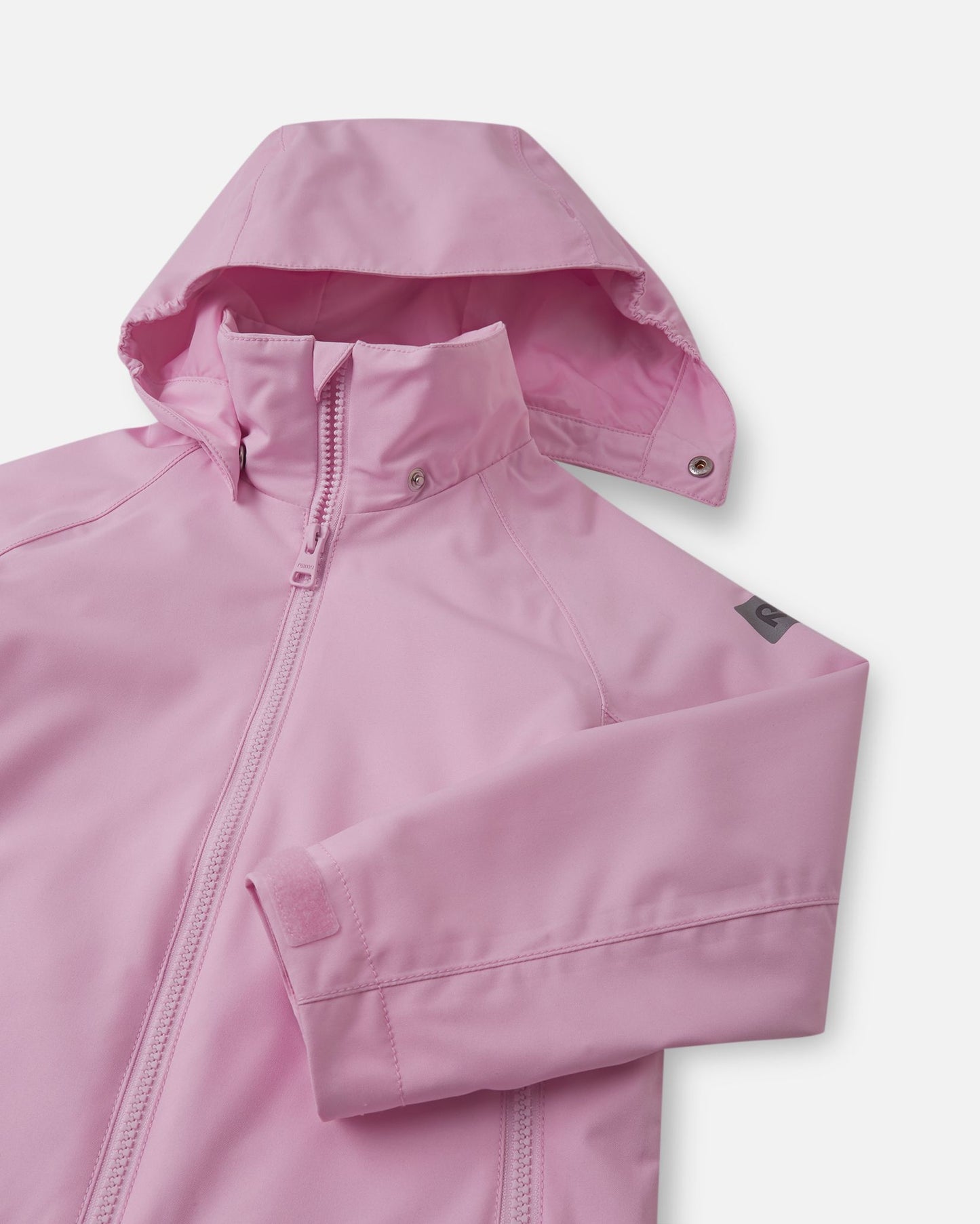 Close-up of the child-safe detachable hood on the light heather pink Reima Sulkava fall jacket, showing the durable snap buttons that easily release if the hood gets snagged on playground equipment.