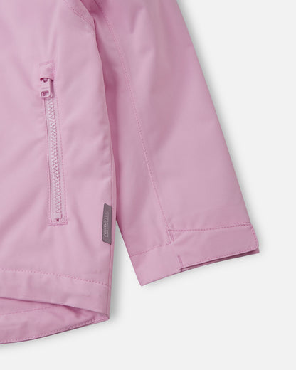 Detail shot of the light heather pink Reima Sulkava jacket, featuring a smooth-running zippered side pocket, a Reimatec waterproof tag, and an adjustable velcro sleeve cuff for a customized, weather-tight fit around the wrists.