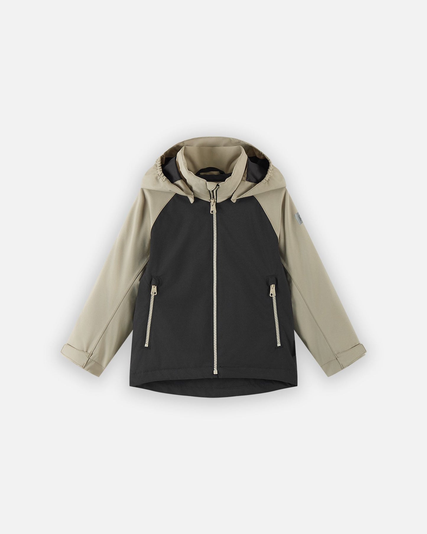 Front view of the Reima Sulkava kids' fall jacket featuring a color-block design with a black body and beige sleeves and hood, equipped with a full zipper, two side pockets, and a protective weather hood.
