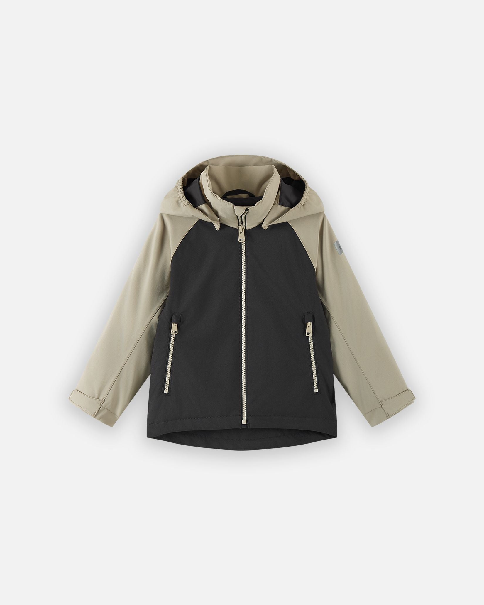 Front view of the Reima Sulkava kids' fall jacket featuring a color-block design with a black body and beige sleeves and hood, equipped with a full zipper, two side pockets, and a protective weather hood.