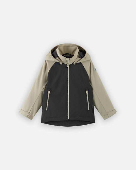 Front view of the Reima Sulkava kids' fall jacket featuring a color-block design with a black body and beige sleeves and hood, equipped with a full zipper, two side pockets, and a protective weather hood.