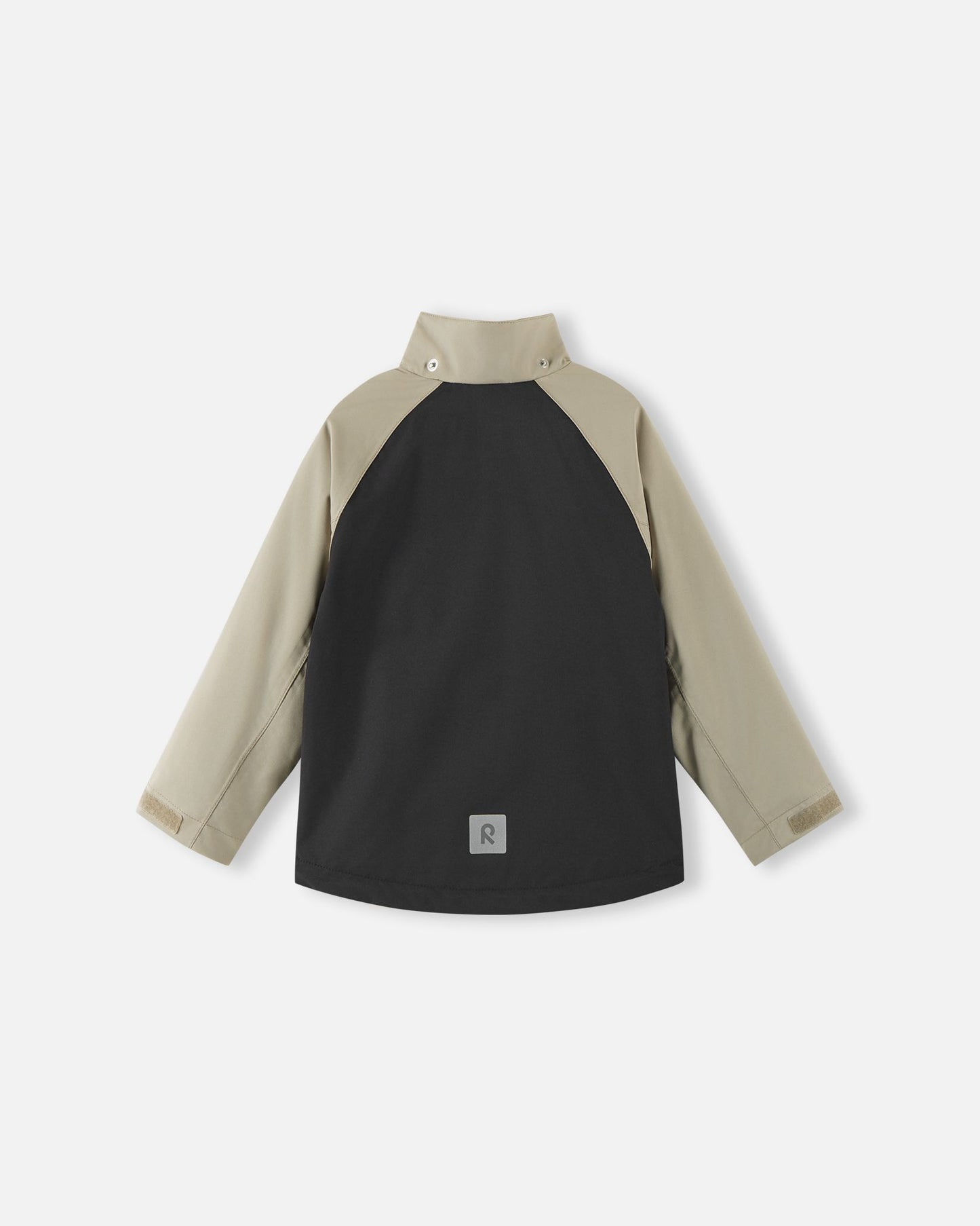 Back view of the color-block black and beige Reima Sulkava kids' fall jacket with the detachable hood removed, revealing a high stand collar that protects the neck from chilly autumn winds.
