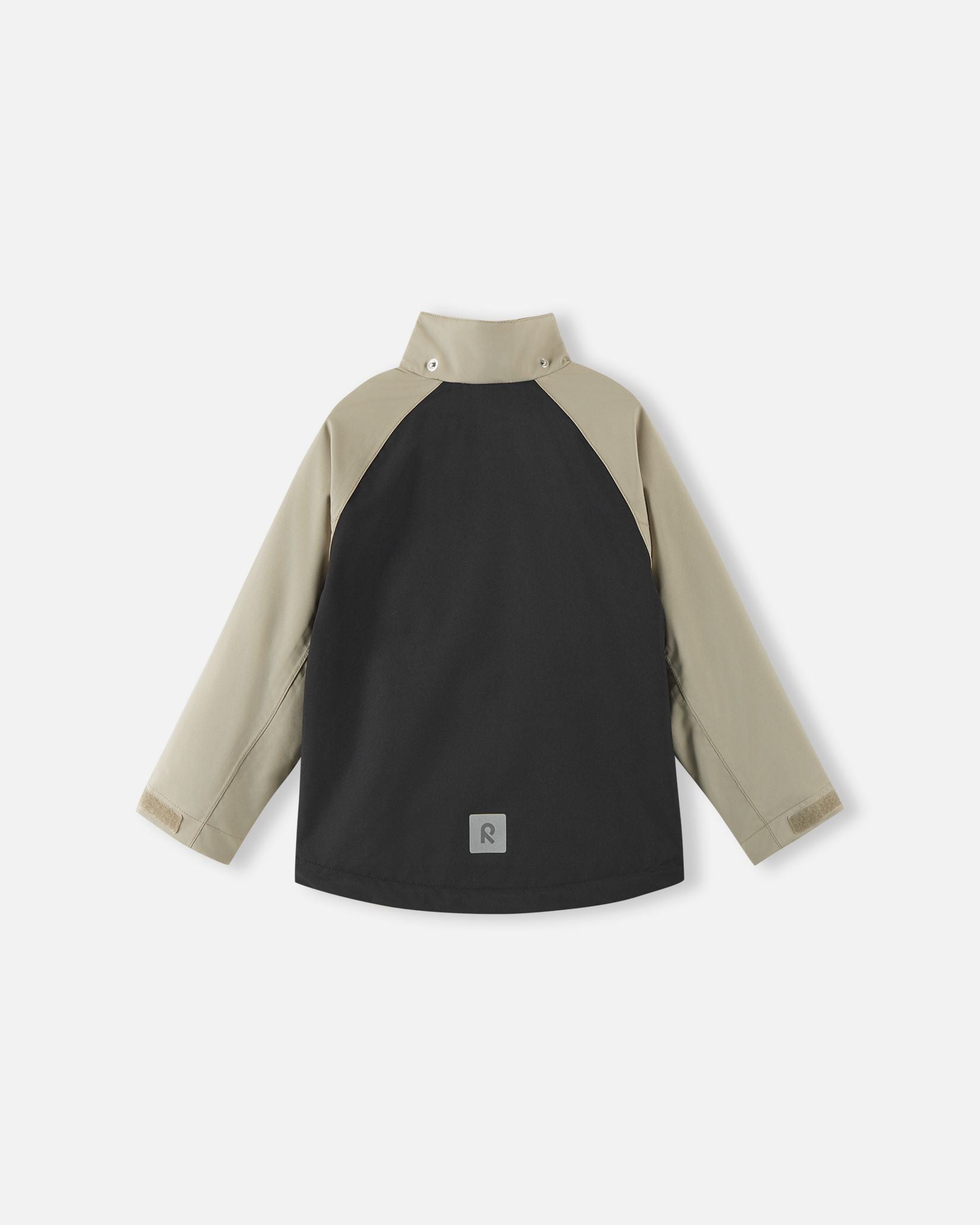 Back view of the color-block black and beige Reima Sulkava kids' fall jacket with the detachable hood removed, revealing a high stand collar that protects the neck from chilly autumn winds.