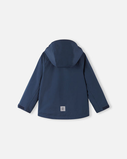 Full back view of the Reima Sulkava kids' fall jacket in navy blue, displaying the attached protective hood and a reflective square Reima safety patch near the lower hem for low-light visibility.