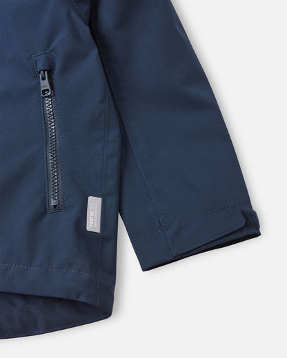 Close-up detail shot of the navy blue Reima Sulkava jacket, highlighting a smooth-running zippered hand pocket, a Reimatec waterproof tag, and an adjustable velcro wrist cuff designed to block out cold drafts.