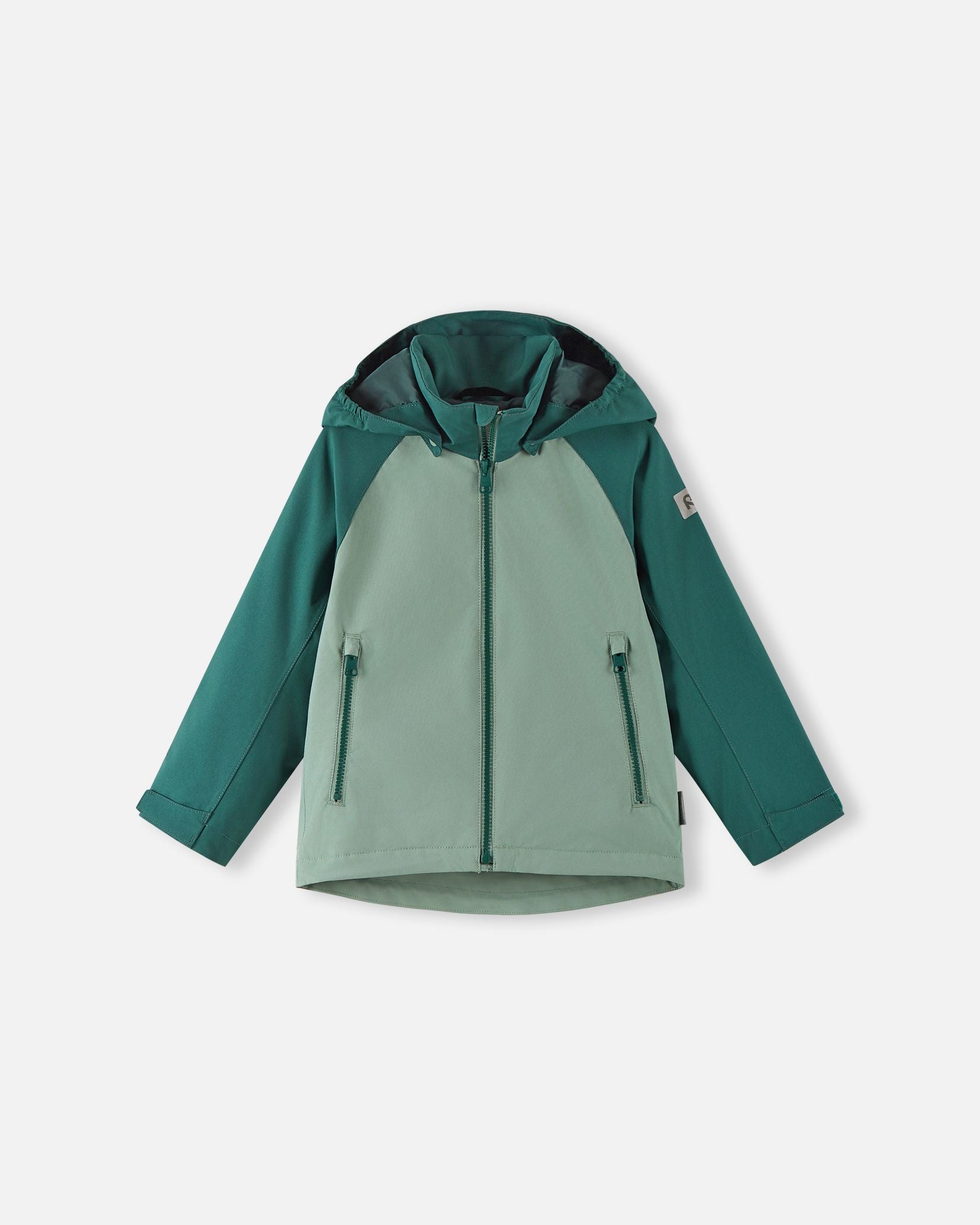 Front view of the Reima Sulkava kids' fall jacket featuring a color-block design in light and dark stone green, equipped with a full-length zipper, two side pockets, and a protective weather hood.