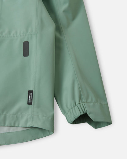 Detailed close-up of the sleeve on the Reima Suojala kids' stone green shell jacket, focusing on the wind-blocking gathered elastic cuff and the Reimatec waterproof technology tag.