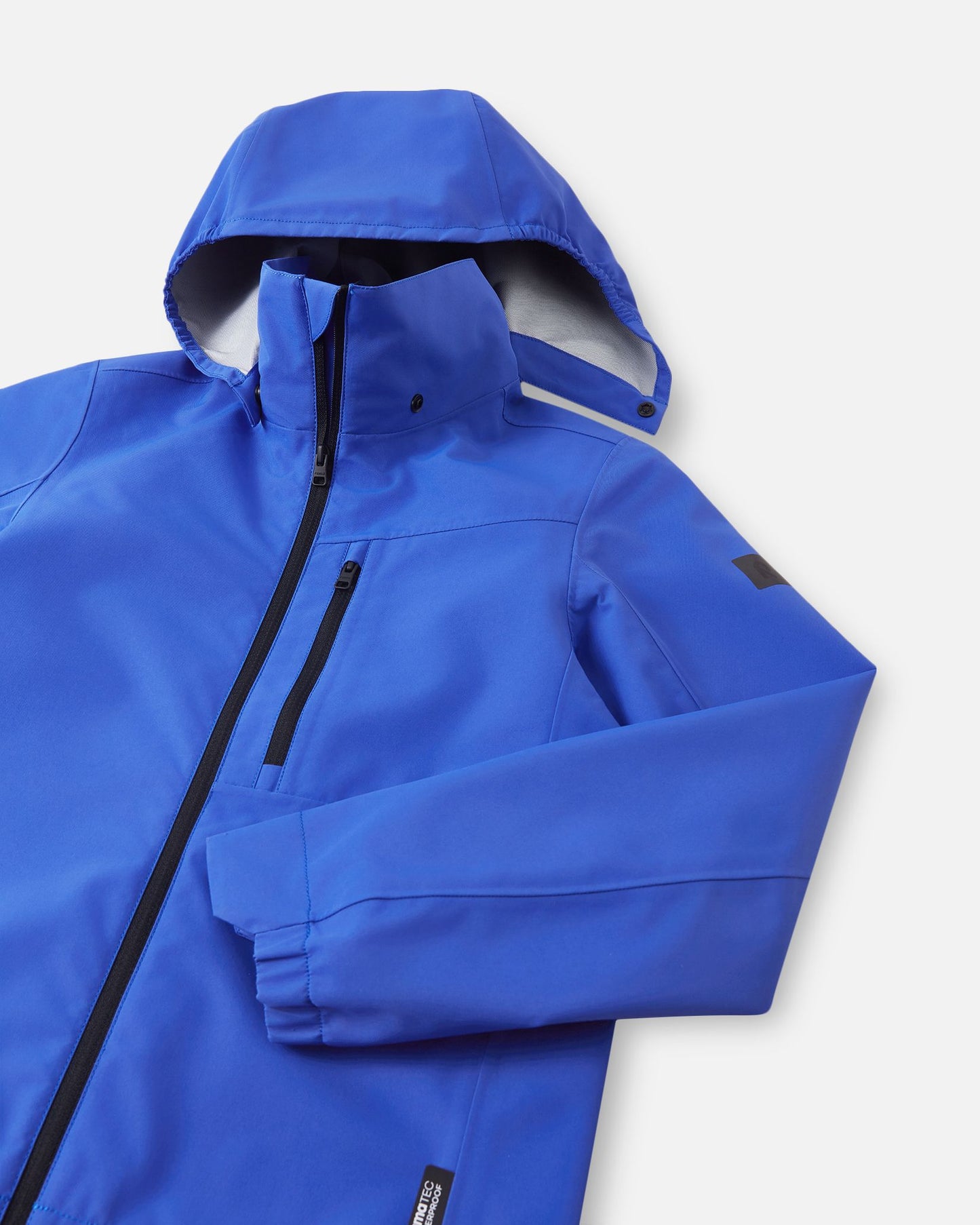 Close-up of the weather-resistant hood and upper chest zipper on the Reima Suojala kids waterproof jacket in sparkly blue.